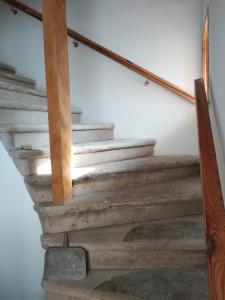 a set of stairs in a home with wooden railings at Grand maison de caractère in Montjaux
