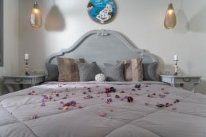 a bed with a bunch of flowers on it at Smaragdi in Perivolos