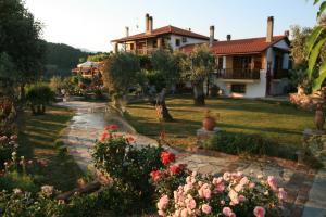 a house with a garden and flowers in the foreground at Vateri in Limne