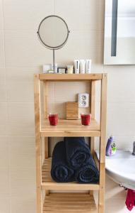 a wooden shelf with towels and a mirror at Apartmán Reggie - Pec pod Sněžkou in Pec pod Sněžkou