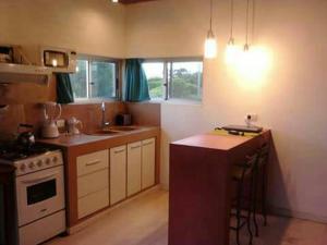 a kitchen with a stove and a counter top at Mar y Cerros in Piriápolis