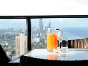 two glasses of orange juice sitting on a table at Luxury 3 Bedroom in heart of Broadbeach in Gold Coast