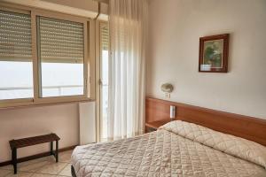 ミラノ・マリッティマにあるHotel Caesar Bed and Breakfastのベッドルーム(ベッド1台、窓付)