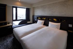 Via Inn Prime Kyotoeki Hachijoguchi客房内的一张或多张床位