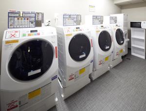a row of washing machines are lined up in a store at Via Inn Prime Kyotoeki Hachijoguchi in Kyoto