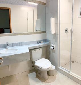 a bathroom with a toilet and a sink and a shower at Meu Hotel Boituva in Boituva