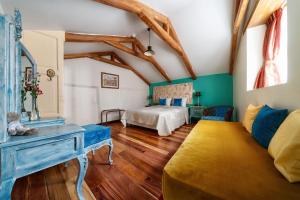 a living room with a bed and a couch at Old Town Quito Suites, Heritage Boutique Hotel, Where Every Detail Tells a Story in Quito