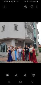 a group of people standing in front of a building at Guesthouse Jelic in Teslić
