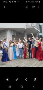 a group of people standing in front of a house at Guesthouse Jelic in Teslić