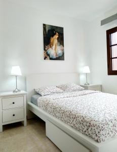 a bedroom with a bed with a painting on the wall at Yellow! in Costa Del Silencio