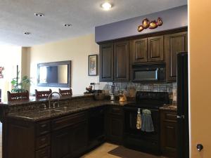 a kitchen with a sink and a stove top oven at BELLA SIRENA RESORT in Puerto Peñasco