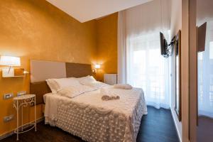 a bedroom with a bed with two shoes on it at Sinestesia in Polignano a Mare