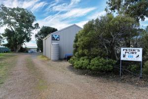 a sign in front of a building with aptic sign at Peter's Port in Pine Point