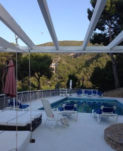 a patio with chairs and a swimming pool at Panoramic 4 Apartments 2B in Castelldefels +19 photos