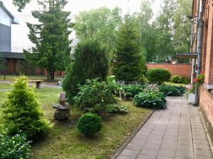 a garden with christmas trees and bushes at Kranto Luxe Stay in Panevėžys