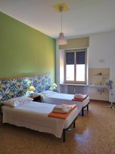 Кровать или кровати в номере Ostello delle cartiere