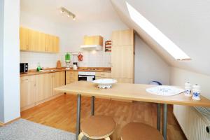 a kitchen with a wooden table and two chairs at Fewo Urlaubsidyll 2_GUeTH in Ostseebad Karlshagen