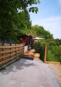a house with a wooden fence and a driveway at Hossegor Les Bécasses in Soorts-Hossegor