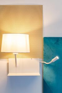a lamp sitting on a shelf next to a wall at Sinestesia in Polignano a Mare
