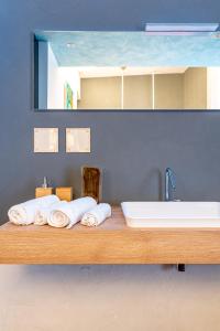 a bathroom with a tub and a sink and towels at Sinestesia in Polignano a Mare
