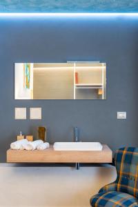 a bathroom with a sink and a counter with towels at Sinestesia in Polignano a Mare