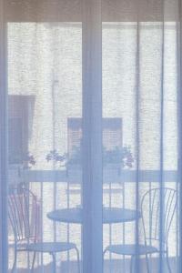 a table and chairs in front of a window at Sinestesia in Polignano a Mare