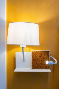 a light on a wall with a lamp on it at Sinestesia in Polignano a Mare