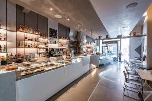 a restaurant with a counter with a lot of food at Sinestesia in Polignano a Mare