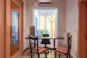 a room with a table with two chairs and a computer at Sinestesia in Polignano a Mare