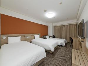 Säng eller sängar i ett rum på Hotel Sunroute Sopra Kobe