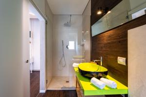a bathroom with a yellow sink and a shower at Sinestesia in Polignano a Mare