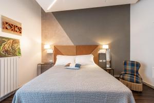 a bedroom with a large bed and two chairs at Sinestesia in Polignano a Mare