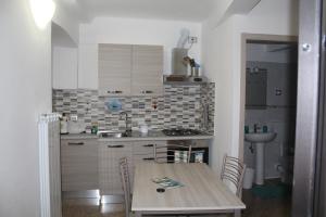 a kitchen with a wooden table and a sink at Tramonto in Mele