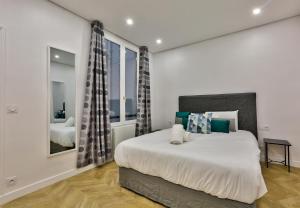 a bedroom with a large bed and a mirror at 92 - Beautiful Apartment in Montorgueil in Paris