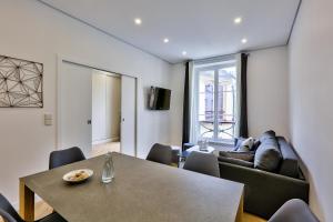 a living room with a table and a couch at 92 - Beautiful Apartment in Montorgueil in Paris