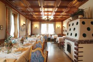a dining room with tables and chairs and a fireplace at Hotel Restaurant Mohren in Rankweil
