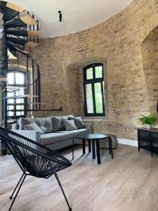 a living room with a couch and a table at Apartamenty Wieża - Tower Apartments in Wałcz