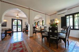 - une salle à manger et un salon avec une table et des chaises dans l'établissement Maison Ayda, à Marrakech