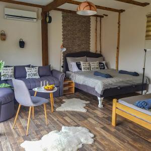 a living room with a bed and a couch and a table at Apartment Little Paradise in Visoko +144 photos