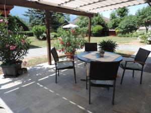 a patio with a table and chairs under a pergola at Haus Assinger in Hermagor
