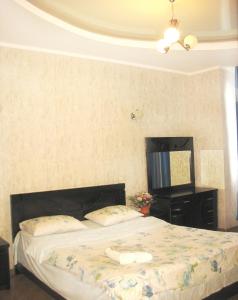 a bedroom with a bed and a dresser and a mirror at Tbilisi Comfort in Tbilisi City