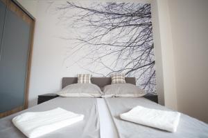 A bed or beds in a room at The Old Mill Budapest