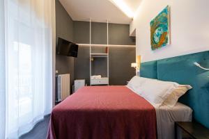 a bedroom with a large bed with a red blanket at Sinestesia in Polignano a Mare
