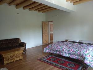 A bed or beds in a room at Chosdup Guest House