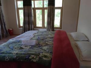 A bed or beds in a room at Chosdup Guest House