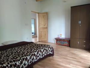 A bed or beds in a room at Chosdup Guest House