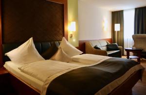 Voodi või voodid majutusasutuse Hotel König toas