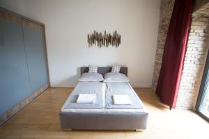 A bed or beds in a room at The Old Mill Budapest