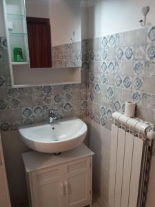 a bathroom with a sink and a mirror at CASA GAIA 3 in Portoferraio