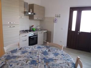 a kitchen with a table with a blue and white pattern at CASA GAIA 3 in Portoferraio